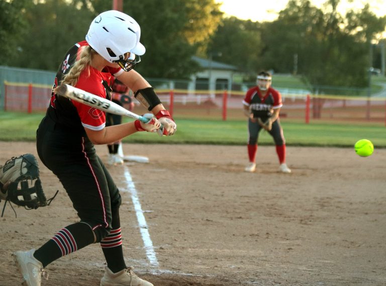 With her team trailing St. Joseph: Benton 6-5 with two outs and runners at second and third base in the bottom of the sixth inning, senior catcher Charley Peniston of the 2025 Chillicothe High School softball Lady Hornets starts the swing which would produce a 2-runs single to right-center field that capped a 6-runs, 2-outs rally and give her team a 7-6 lead. Winning by that score a few minutes later, Chillicothe clinched its sixth Midland Empire Conference championship in a row. (PAUL STURM/C-T PHOTO)