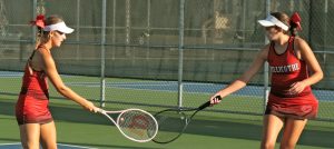 2025 Chillicothe High School tennis Lady Hornets Lexy Smith, left, and Lydia Bonderer touch racquet in fleeting celebration of winning a point during their Class 1 District 8 doubles championship match Oct. 10. The CHS tandem, each of whom took up the sport only at the start of the 2024 high school season, not only added the district doubles title to their quickly-growing resum Ð which already had gained the listing of Midland Empire Conference doubles champions Ð that day, but tacked on earning eighth place in the Class 1 state tournament at Springfield this past Thursday and Friday with two wins in five matches. (PAUL STURM/C-T FILE PHOTO)